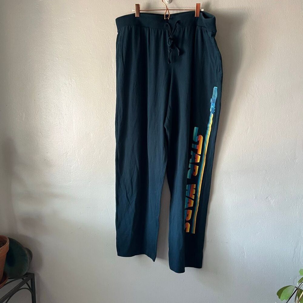 Disney black Star Wars lounge pants feature a colorful lightsaber graphic runnin